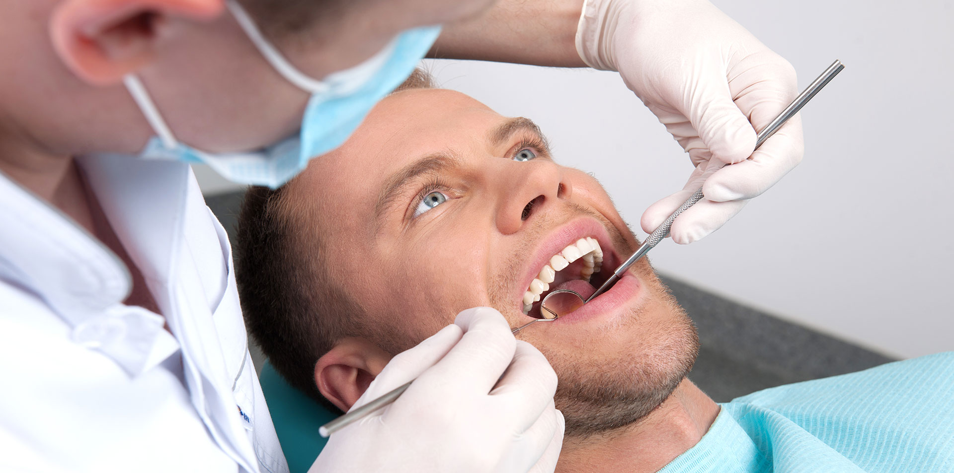 Стоматолог выявляет наличие кариеса у пациента